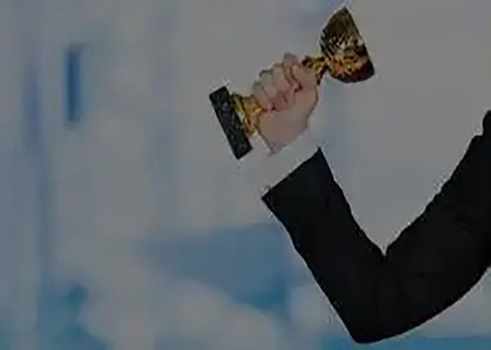 Business professional holding a trophy, celebrating an award for outstanding business achievements