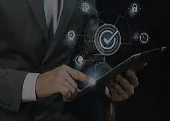 Business professional using a tablet with digital icons representing quality assurance, security, and business process management.