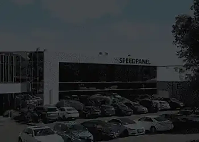 Exterior view of the Speedpanel office building with parked cars in the foreground.
