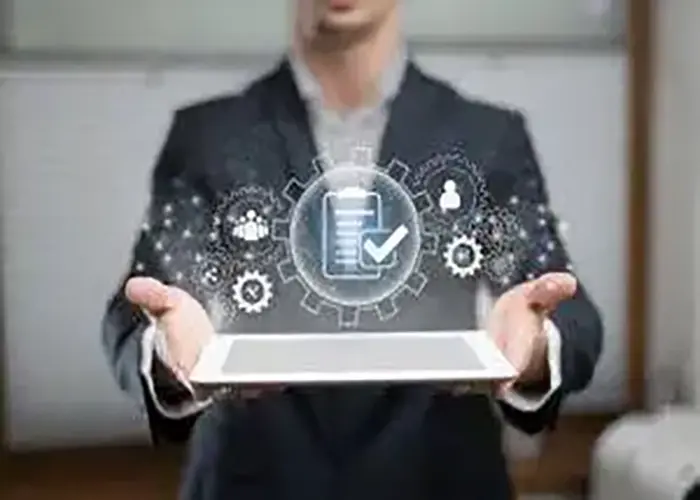 Business professional holding a tablet with digital icons representing workflow automation, data management, and enterprise integration.